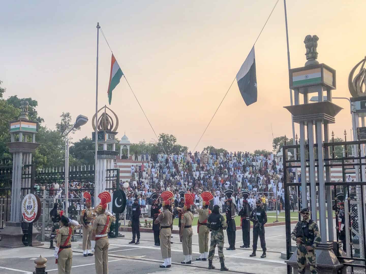 Wagah Border Ceremony - The Wandering Quinn Travel Blog Wagah Border Ceremony flags being pulled down at border