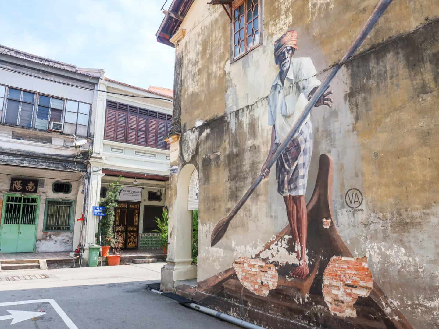 Georgetown street art man in boat - Georgetown Penang Malaysia Guide famous street art | best places to travel in Asia December and January