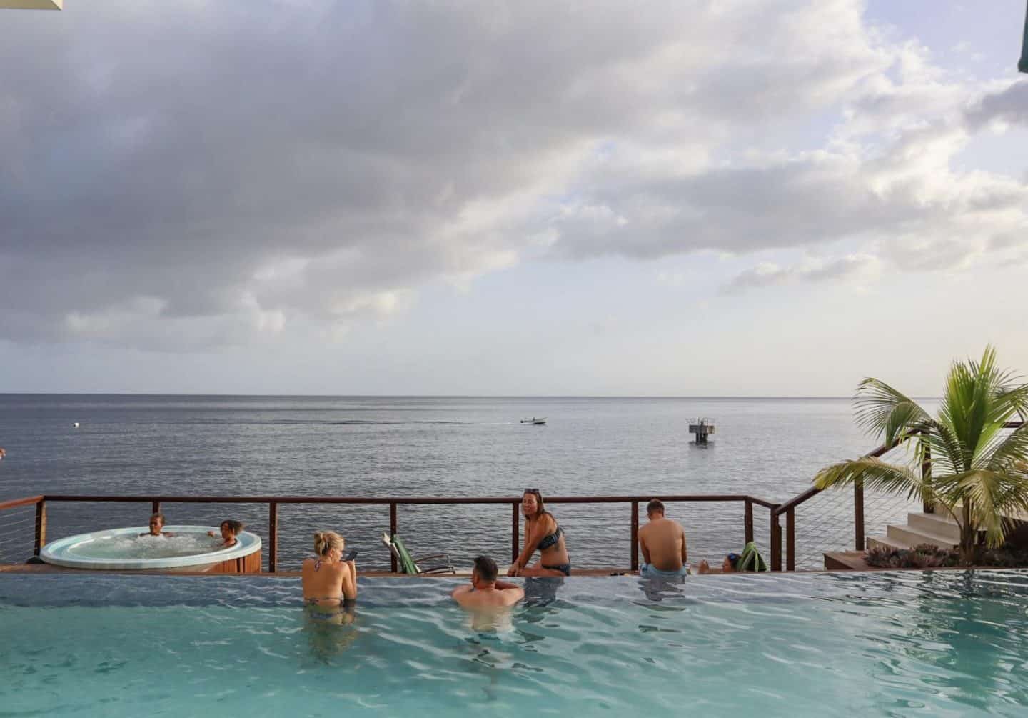 rain clouds in dominica in July - dominica travel guide, fort young hotel pool and ocean with rain clouds above in July