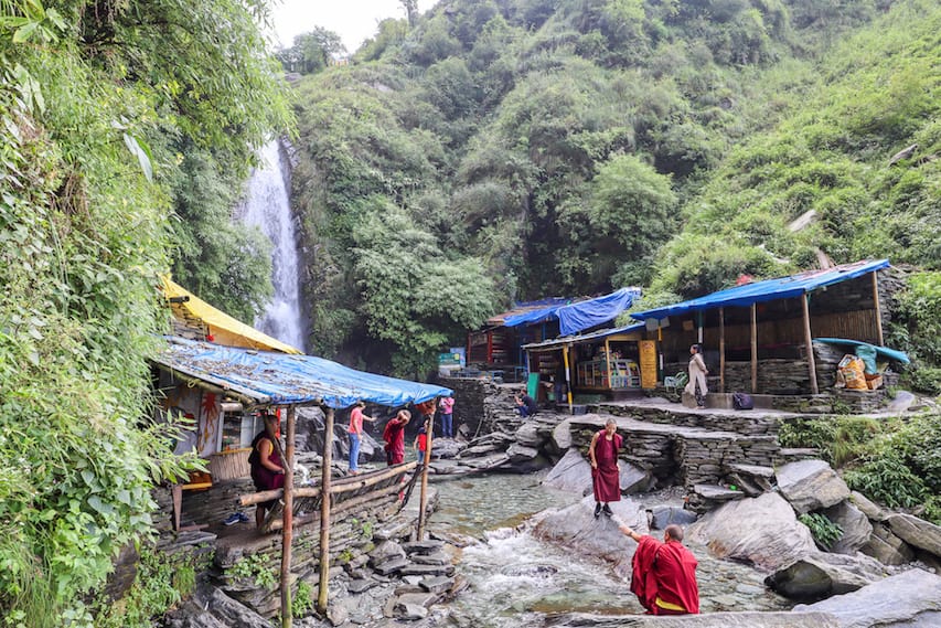Bhagsu Waterfall - Bhagsu Waterfall base with monks by water | things to do in Bhagsu