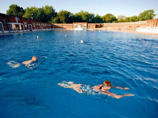 hampstead heath lido - hampstead heath lido with people swimming