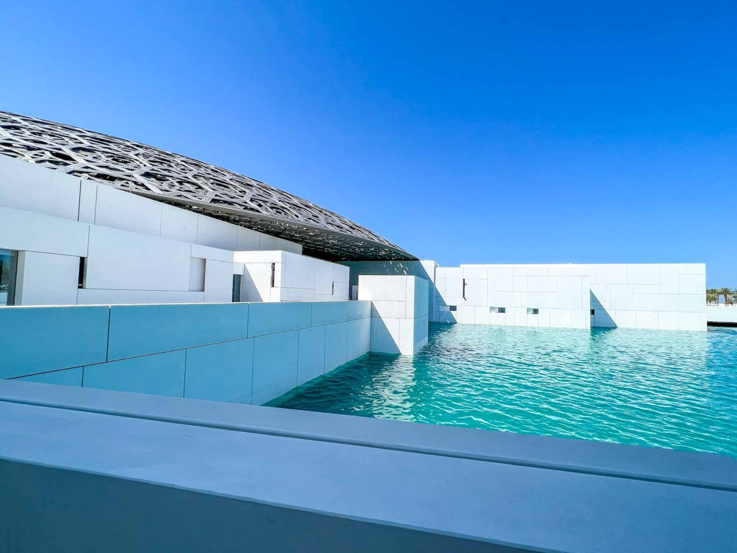 Things to do in Abu Dhabi, The Louvre from outside with blue water - Things to do in Abu Dhabi, The Louvre from outside with blue water