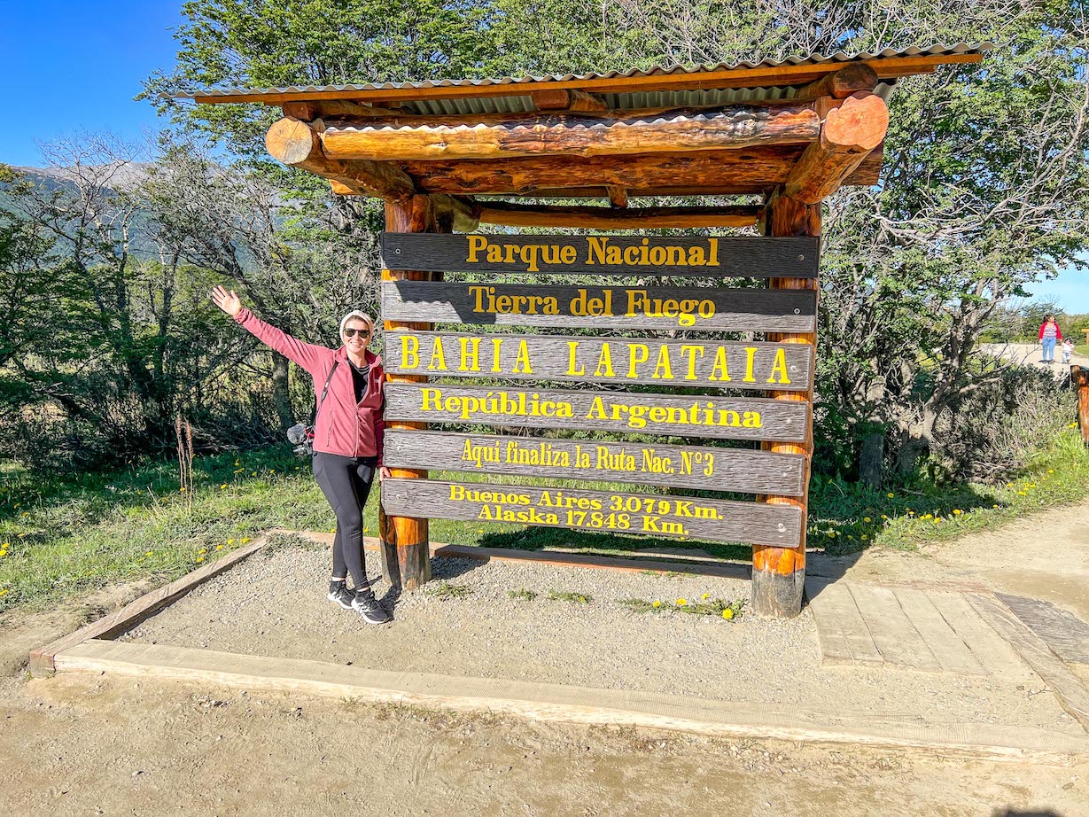 things to do in Ushuaia, Ellie at Tierra del Fuego National Park sign - things to do in Ushuaia, Ellie at Tierra del Fuego National Park sign