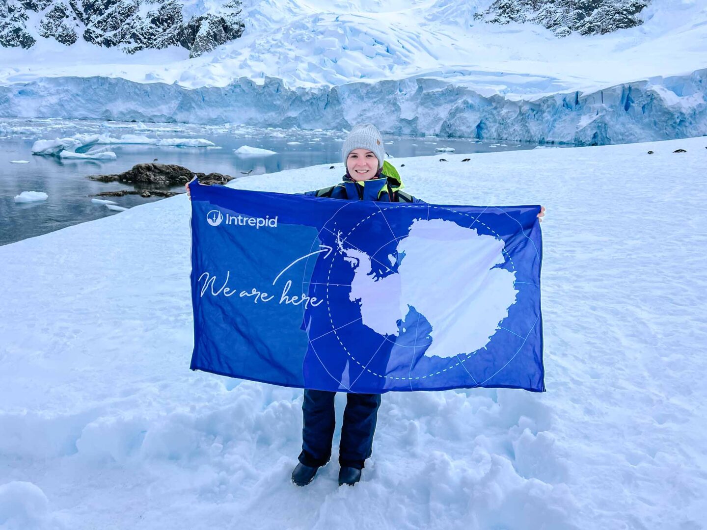 Ellie with Antarctica flag, 7th continent, Can you visit Antarctica, Why do people visit Antarctica, - The Wandering Quinn Travel Blog Ellie with Antarctica flag, 7th continent, Can you visit Antarctica, Why do people visit Antarctica,