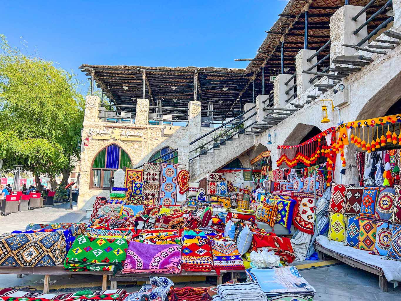 colourful carpets outside shop in Souk Waqif, Doha itinerary, Qatar itinerary, - The Wandering Quinn Travel Blog colourful carpets outside shop in Souk Waqif, Doha itinerary, Qatar itinerary,