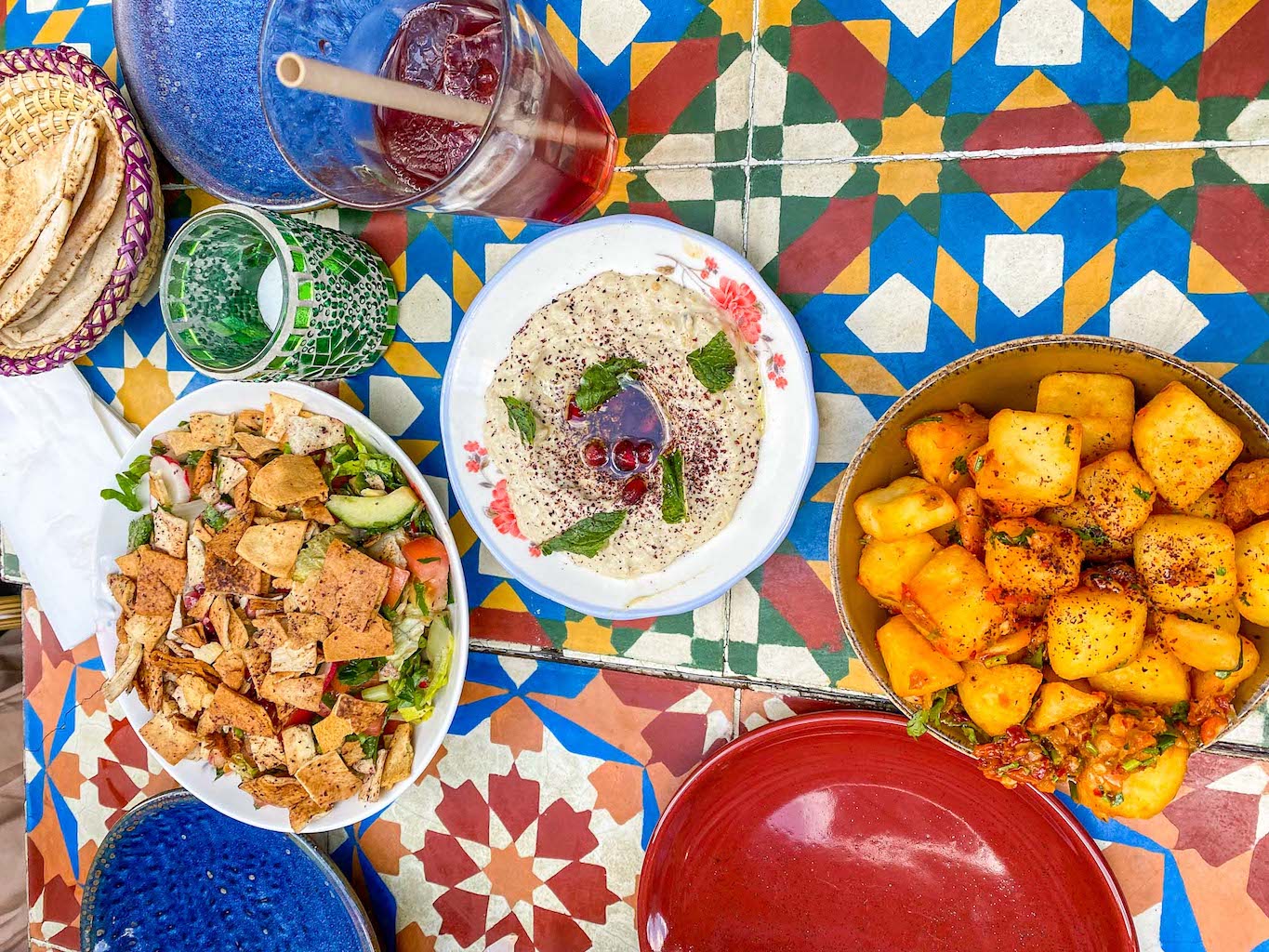 halal restaurants in manchester, selection of food from Comptoir Libanais on colourful table - halal restaurants in manchester, selection of food from Comptoir Libanais on colourful table