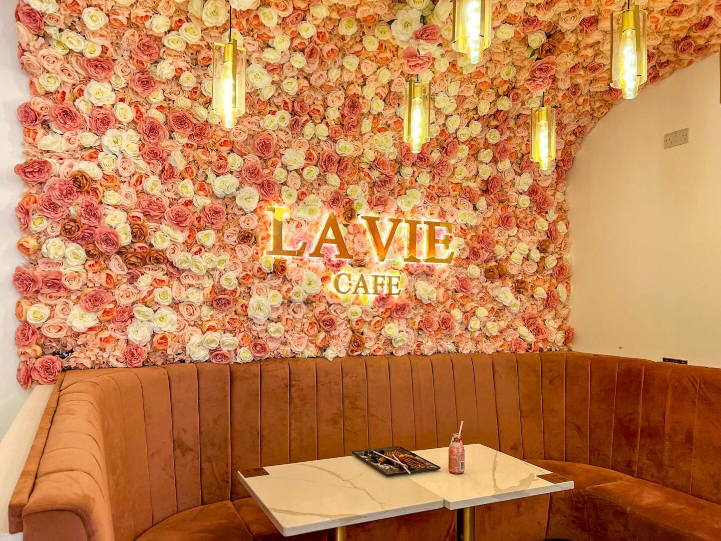Halal brunch manchester, Inside La Vie Cafe with flowers on wall - Halal brunch manchester, Inside La Vie Cafe with flowers on wall
