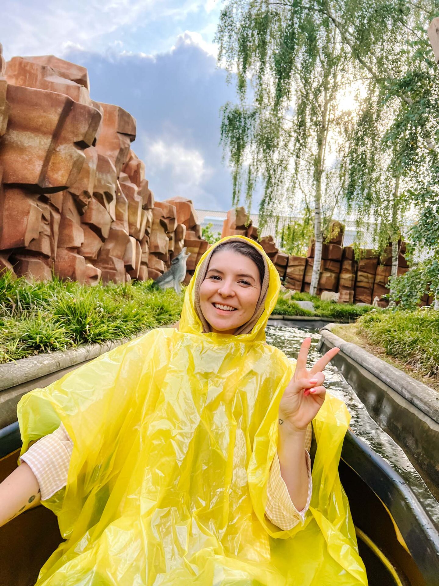 how to visit LEGOLAND Billund, Ellie in poncho on canoe water ride - how to visit LEGOLAND Billund, Ellie in poncho on canoe water ride