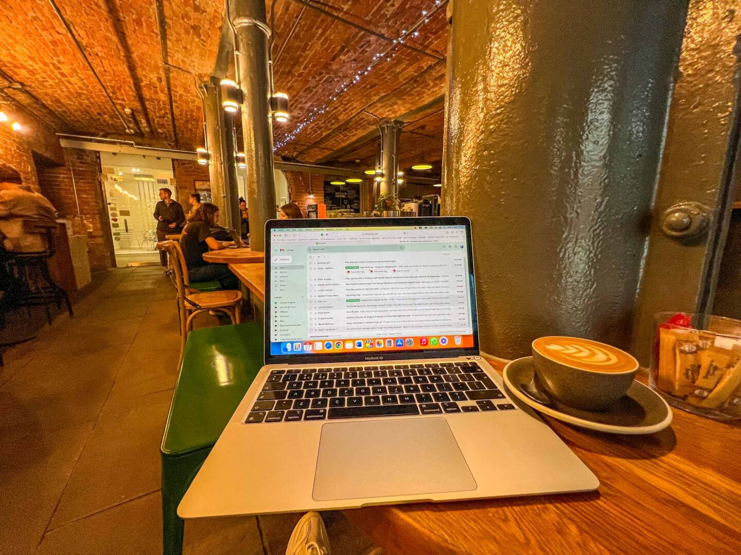 Ancoats Coffee with laptop - Manchester cafes to work from, Ancoats Coffee inside with laptop and coffee