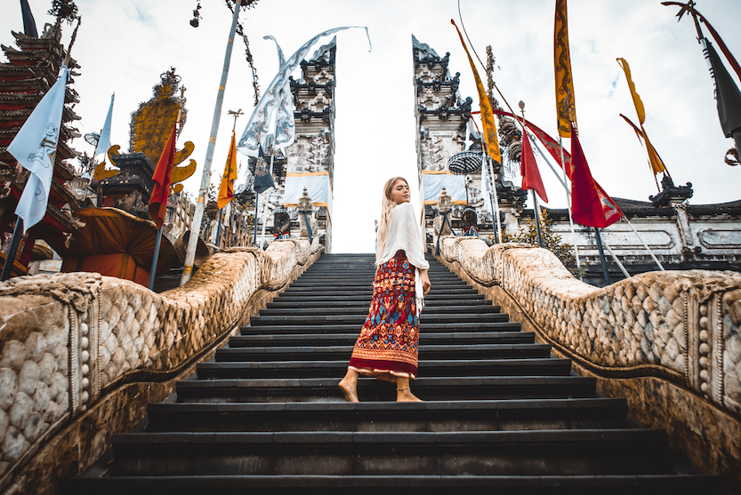 Packing List Bali, female at temple gates in Bali in appropriate clothing - Packing List Bali, female at temple gates in Bali in appropriate clothing
