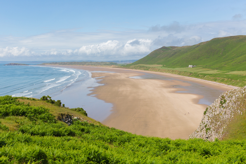 best beaches in South Wales, view of Rhosili Bay Beach from the coastal path above - best beaches in South Wales, view of Rhosili Bay Beach from the coastal path above