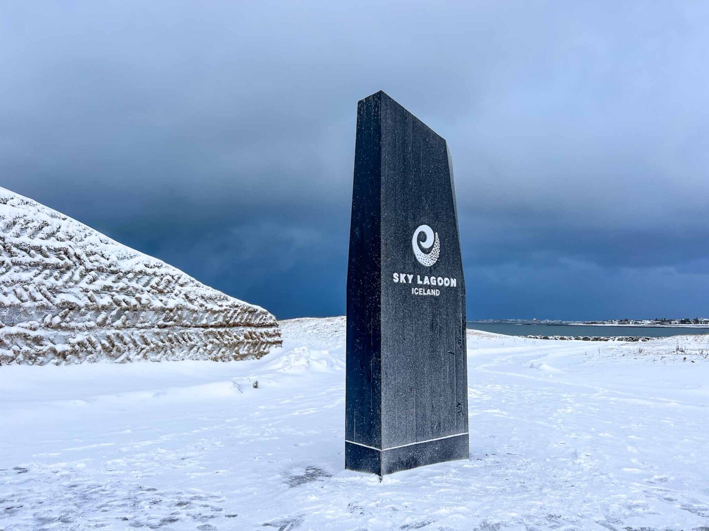 Iceland 4 days, sky lagoon sign and entrance with snow - The Wandering Quinn Travel Blog 4 day iceland itinerary, Iceland 4 days, sky lagoon sign and entrance with snow