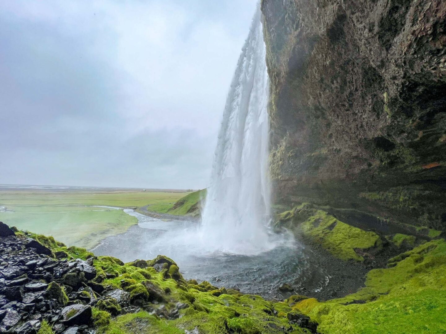 4 day iceland itinerary, Seljalandsfoss waterfall from behind - 4 day iceland itinerary, Seljalandsfoss waterfall from behind