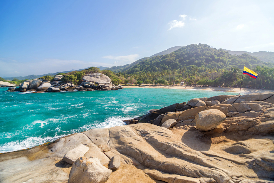 Best countries to visit in August, Beach and Colombian Flag - Best countries to visit in August, Beach and Colombian Flag
