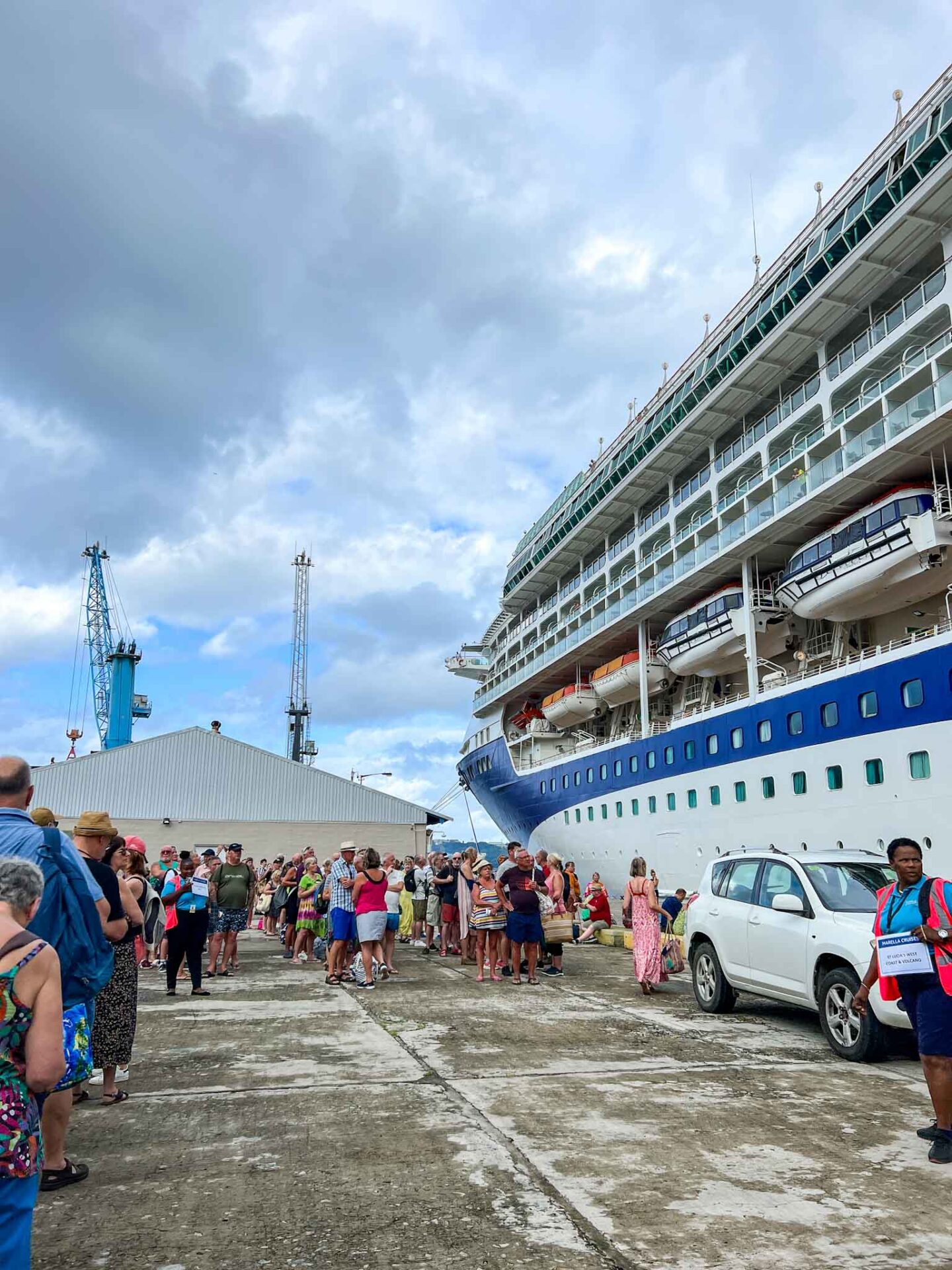 Tui cruise review, guests waiting outside Marella Discovery 2 for morning excursions to start 