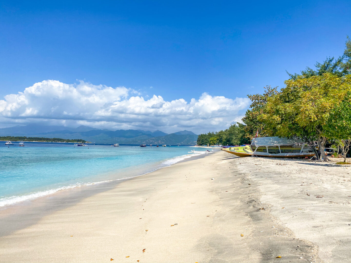 Best countries to visit in August, beach with white sand and blue water on Gili Trawangan - Best countries to visit in August, beach with white sand and blue water on Gili Trawangan