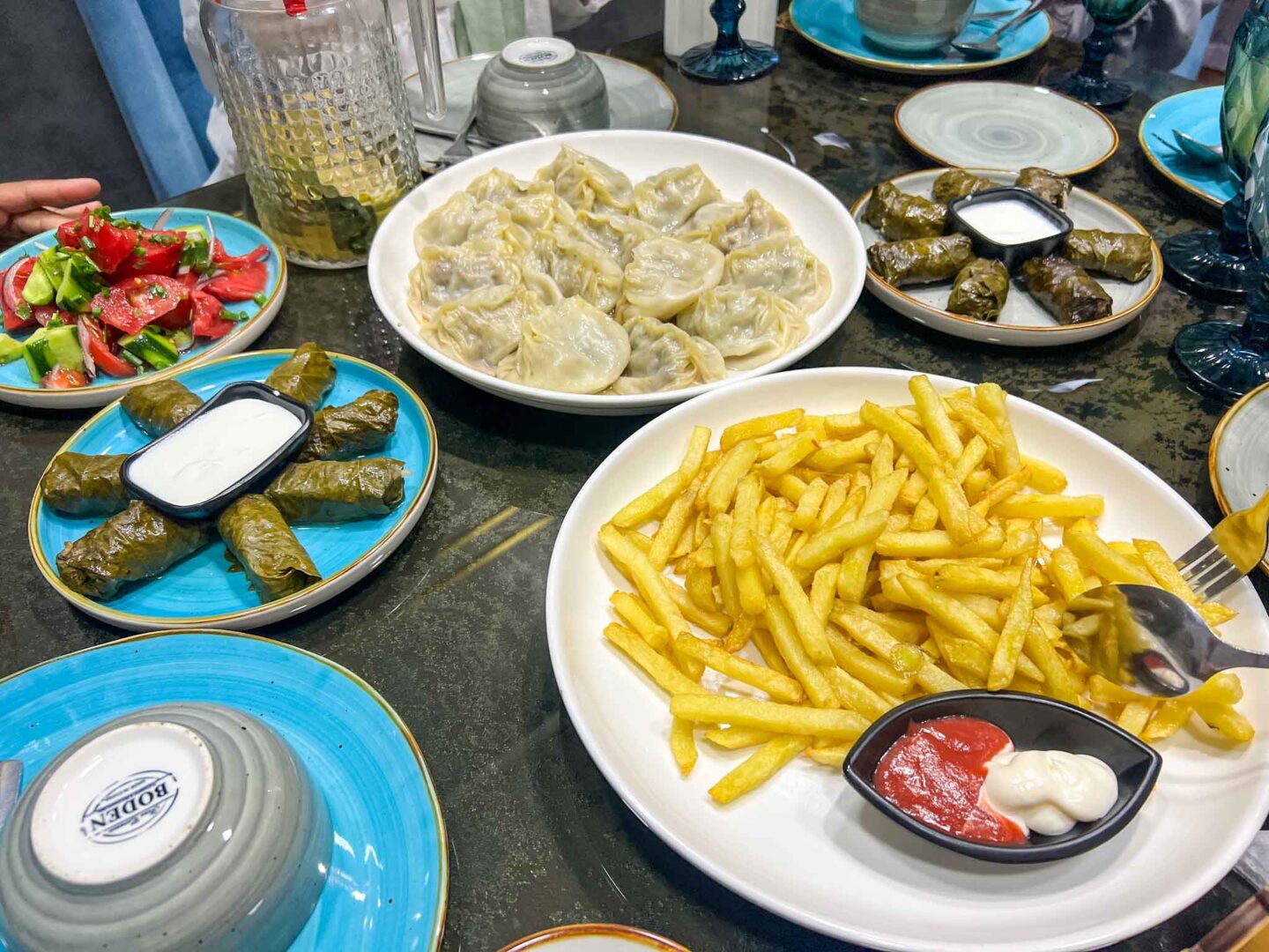halal travel in Uzbekistan, manti and a table of other foods in Uzbekistan - halal travel in Uzbekistan, manti and a table of other foods in Uzbekistan