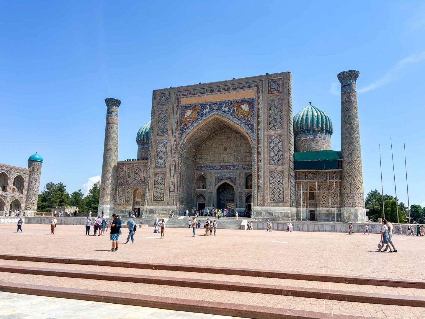 What to wear Uzbekistan, tourists walking around Registan Square Samarkand - What to wear Uzbekistan, tourists walking around Registan Square Samarkand