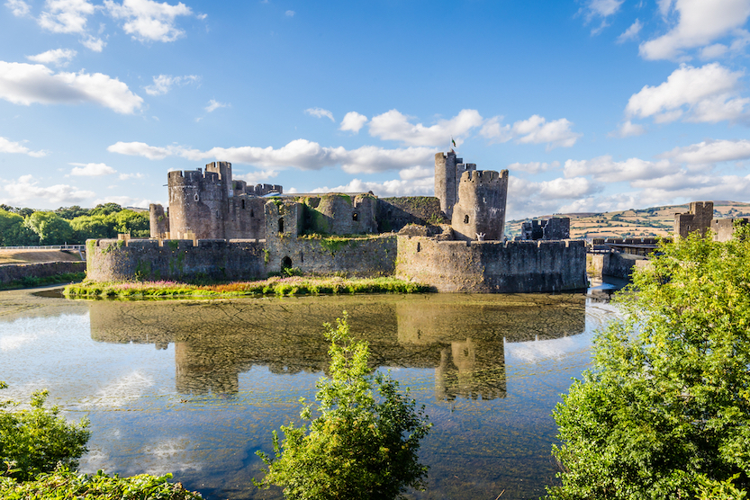 Day trips from Cardiff by train, Caerphilly Castle with blue sky - Day trips from Cardiff by train, Caerphilly Castle with blue sky
