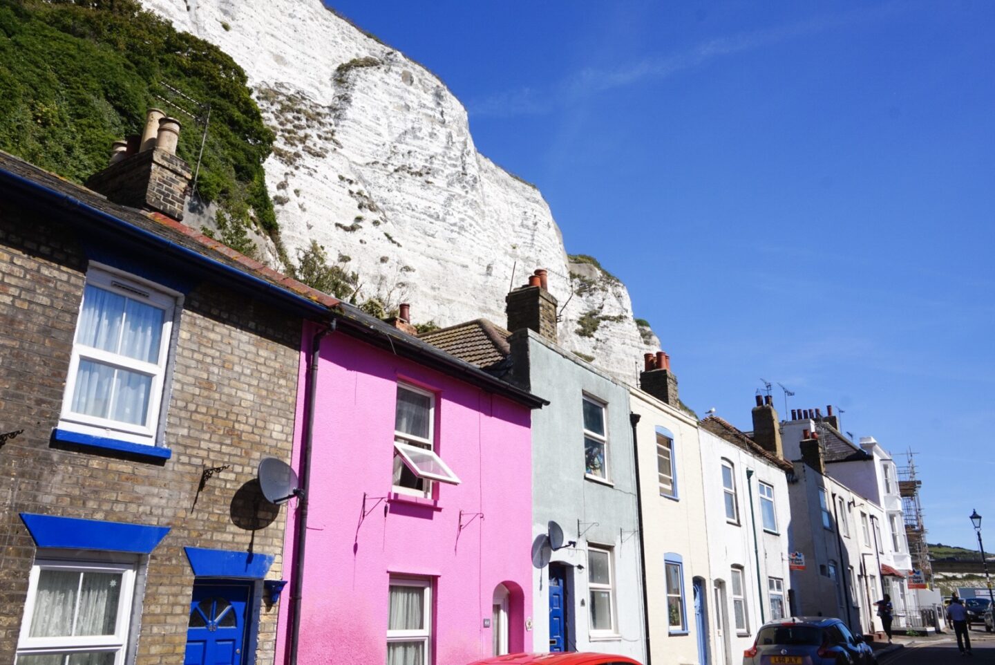 colourful houses with white cliffs behind them - colourful houses with white cliffs behind them