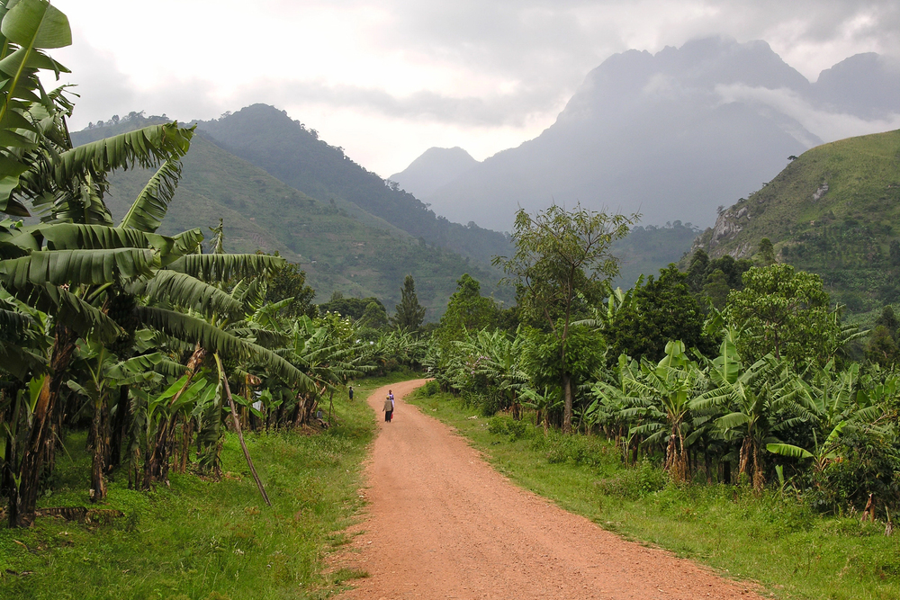 best countries to visit in July, dirt road in Uganda with mountains