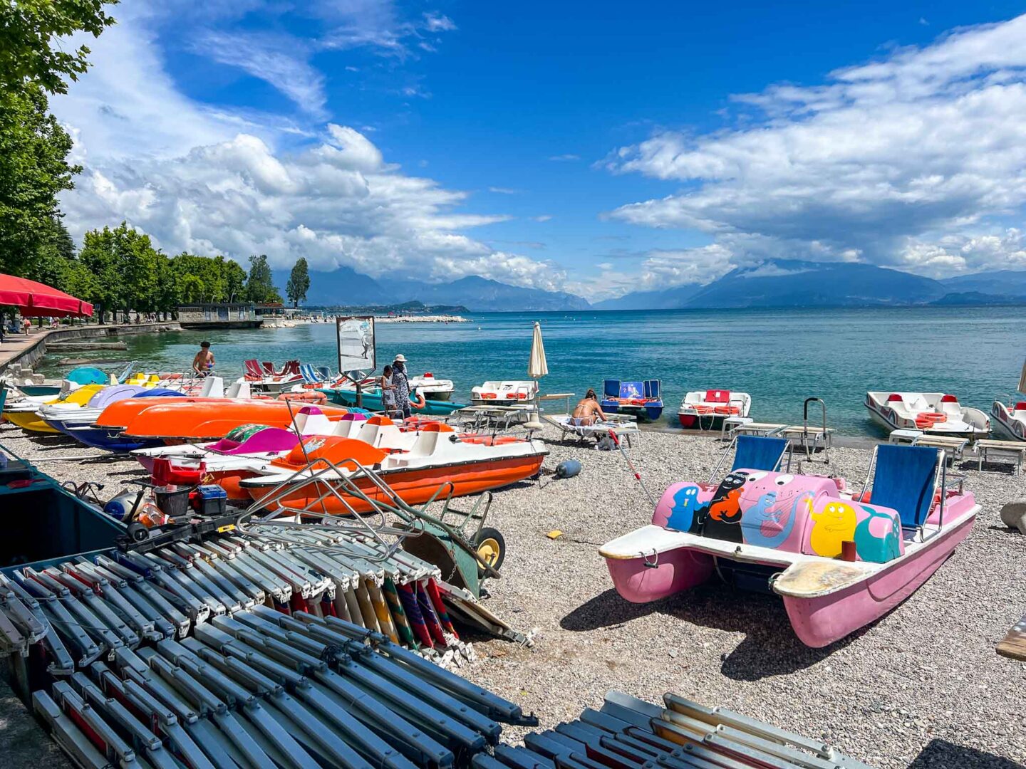 best countries to visit in July, boats on the shore of Lake Garda