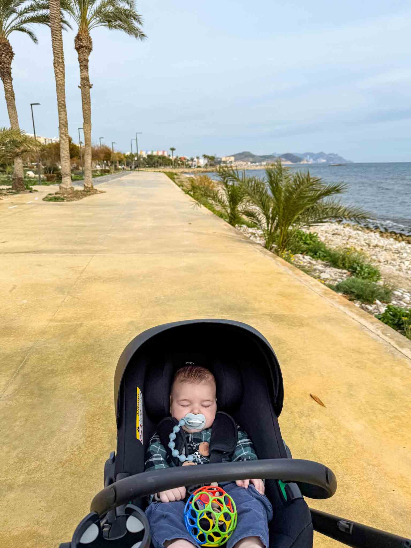baby asleep by the sea in Alicante, Alicante with a baby