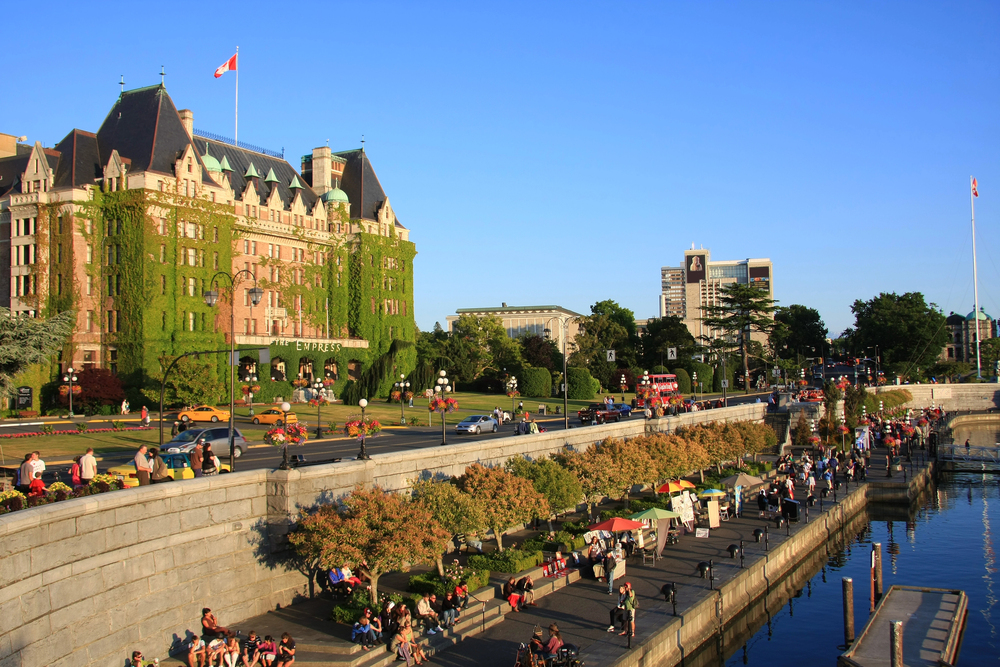best countries to visit in June, people sitting on pier in Canadian city