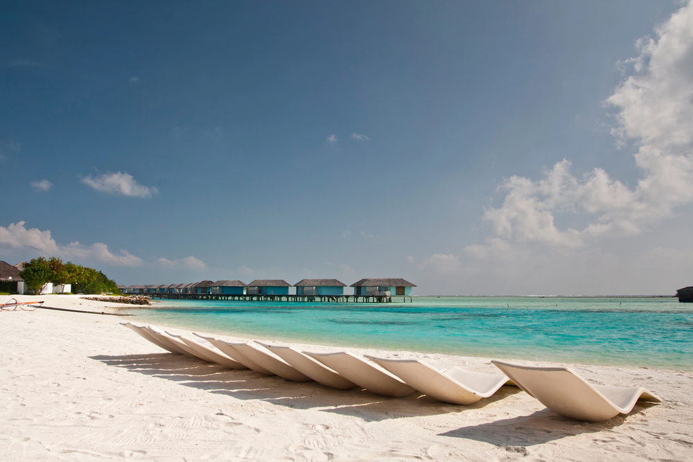 best places in asia to visit in may, best places to visit in asia in June, beach with loungers in the Maldives 