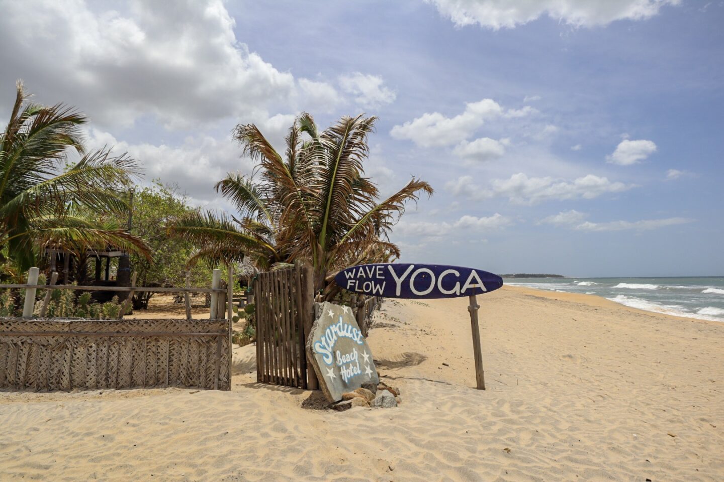 best places in asia to visit in may, best places to visit in asia in June, beach and yoga sign in Aragam Bay, Sri Lanka